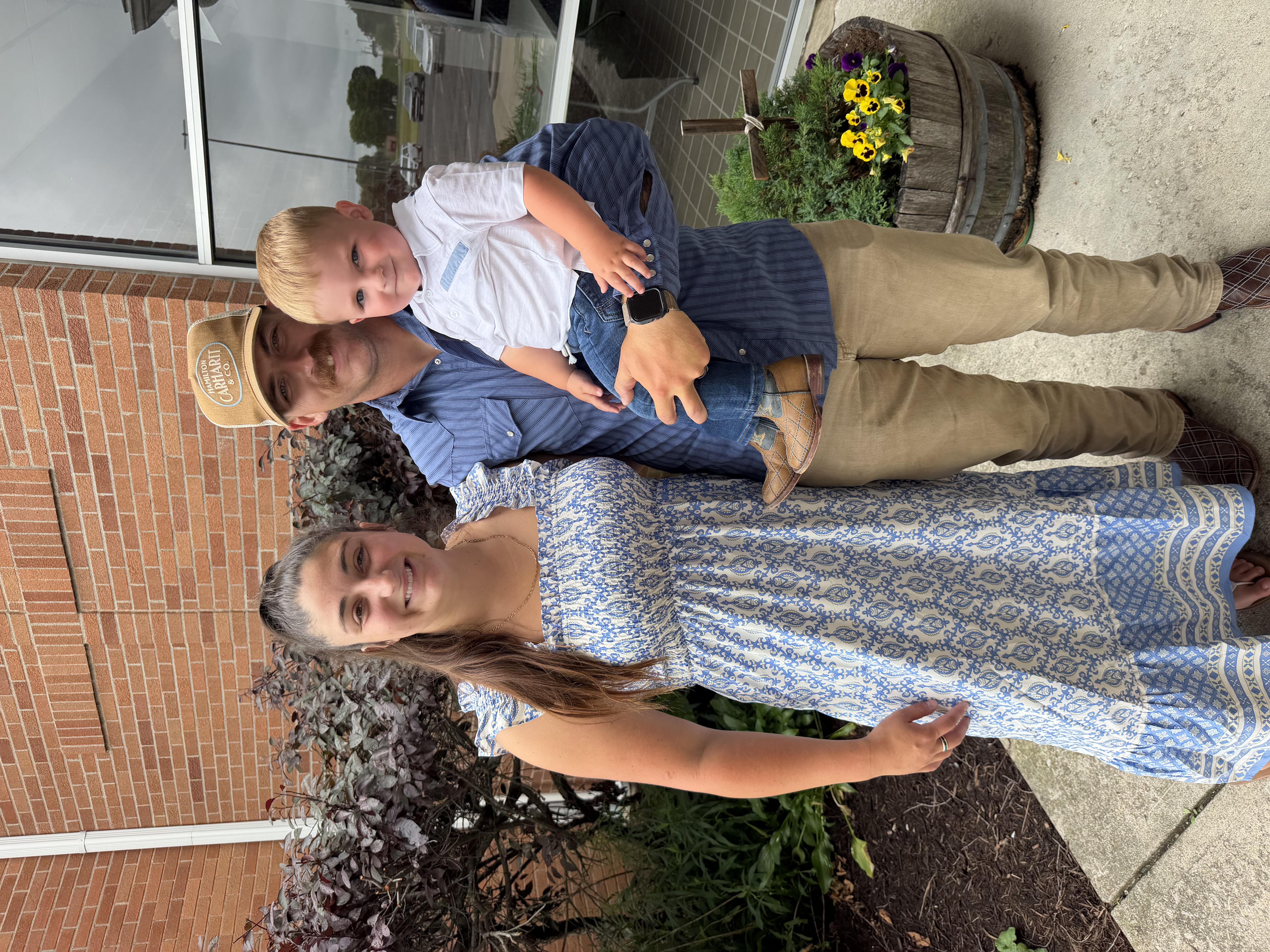 The family owners of Sunrise 2 Sunset Landscaping standing together outdoors